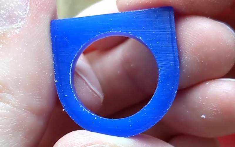 Close up of a piece of flat tube blue ring wax