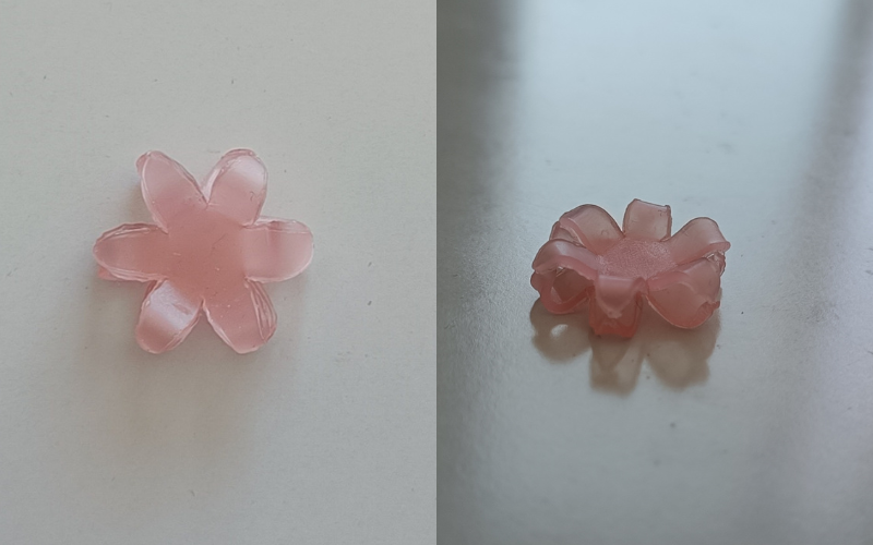 2 photos side by side of the same piece from different angles. 2 flower shapes layered together with the tips of the petals and the center touching creating open spaces between the petals. Left photo from top, right from the side so you can see the spaces between the petals. 