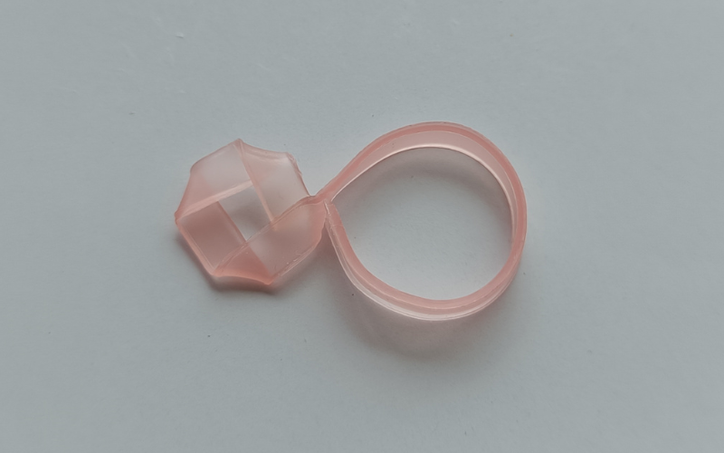 a ring with a folded square part on top