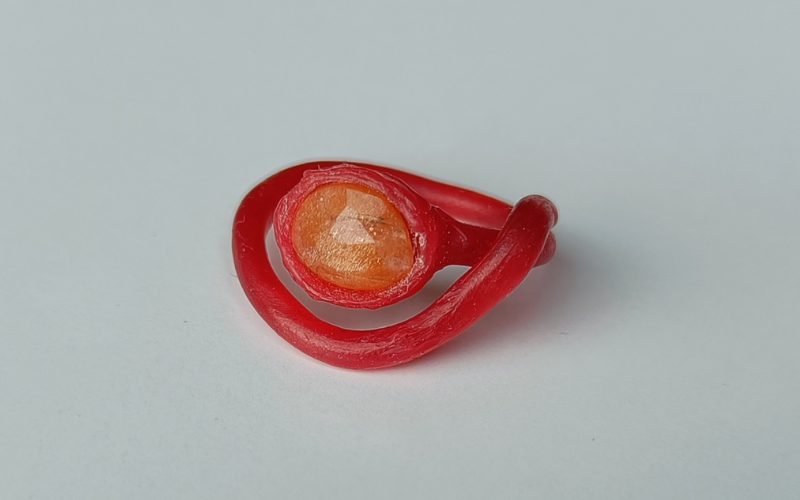 Ring from red wax with a sunstone 