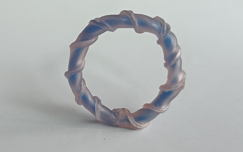 Ring from pink sheet wax that's twisted together, a blue wire is inside.